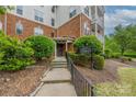 Building entrance featuring well-maintained landscaping, a pathway, and signage at 11544 Costigan Ln # 8306, Charlotte, NC 28277