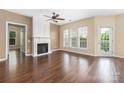 Bright living room with hardwood floors, a fireplace, and large windows at 11544 Costigan Ln # 8306, Charlotte, NC 28277