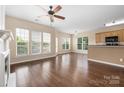 Spacious living room with hardwood floors, large windows, and a ceiling fan at 11544 Costigan Ln # 8306, Charlotte, NC 28277