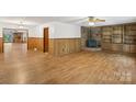 Spacious living room featuring a cozy fireplace, wood floors, and natural light at 119 Legacy Ln, Harmony, NC 28634