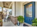 Inviting front porch with stone accents and a stylish blue front door at 1226 Clingman Dr, Fort Mill, SC 29715
