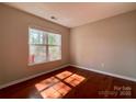 Bright bedroom with hardwood floors and a large window offering natural light at 1745 Matheson Ave, Charlotte, NC 28205