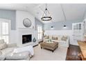 Bright living room with vaulted ceiling, fireplace, modern lighting, and stylish decor at 200 Port Royal Dr, Matthews, NC 28105