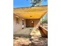 Exterior carport area with brick walls, a concrete floor and yellow ceiling at 204 Long Creek Rd, Bessemer City, NC 28016