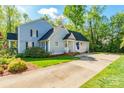 Home's side exterior featuring a spacious driveway and well-maintained lawn at 2166 Potpourri Pt, Rock Hill, SC 29732