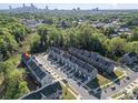 Overhead shot of gray townhouses in a lush, green community near the city with easy access to highways at 2410 Dr Carver Rd, Charlotte, NC 28208