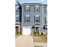 Beautiful three-story townhouse with attached garage and front lawn, perfect for modern living at 2410 Dr Carver Rd, Charlotte, NC 28208