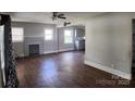 Open living room view featuring brick fireplace and access to the kitchen at 2607 Lowell Rd, Gastonia, NC 28054