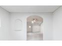 Bright and airy living room showcasing archways, neutral paint, light flooring, and decorative niche at 2616 Holton Ave, Charlotte, NC 28208