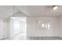 Bright living area features sleek gray floors, large mirror, modern lighting, and seamless flow to other rooms at 2616 Holton Ave, Charlotte, NC 28208