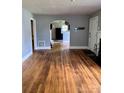 Spacious living room showcasing hardwood floors, arched doorway and natural light at 3507 Rogers St, Charlotte, NC 28208