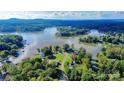 A scenic aerial view of a waterfront property with lush greenery and a peaceful lake setting at 3915 Chevlot Hills Rd, Sherrills Ford, NC 28673