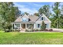 Charming exterior of a two-story home with a welcoming front porch and manicured lawn at 3915 Chevlot Hills Rd, Sherrills Ford, NC 28673