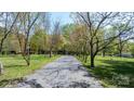 Long, tree-lined driveway leading to the residence with surrounding green landscape at 4067 Old Buff Rd, Hickory, NC 28602