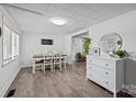 Bright dining room with stylish flooring, a white dresser, and a decorative mirror at 4436 Shiloh Unity Rd, Lancaster, SC 29720