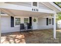 Inviting front porch with rocking chairs, a welcoming wreath on the door, and classic black shutters at 4436 Shiloh Unity Rd, Lancaster, SC 29720