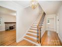 Bright foyer with hardwood floors, a staircase, and a view of the living room at 45 Mckinnon Ne Ave, Concord, NC 28025