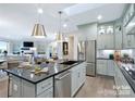 Spacious kitchen with island, stainless steel appliances, and open layout to the living area at 4813 Reason Ct # 75, Harrisburg, NC 28075