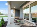 Inviting covered porch with rocking chairs, perfect for relaxing and enjoying the outdoors at 4813 Reason Ct # 75, Harrisburg, NC 28075