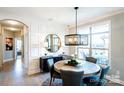 Elegant dining area with round wooden table, comfortable seating for six, and modern decor and lighting at 4825 Reason Ct # 73, Harrisburg, NC 28075