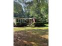 Traditional one-story home featuring lush landscaping, a welcoming front porch, and wooded surroundings at 5029 E Nc 10 Hwy Rd # 6, Catawba, NC 28609