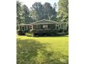 Inviting home featuring a manicured lawn, front porch, and an American flag at 5029 E Nc 10 Hwy Rd # 6, Catawba, NC 28609