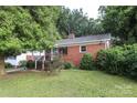 A quaint single-story brick home with a well-maintained lawn and mature trees at 516 Northgate Ave, Charlotte, NC 28209