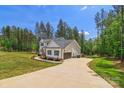 Long driveway leading to a well-maintained home with an attached garage and verdant surroundings at 545 Morrison Farm Rd, Troutman, NC 28166
