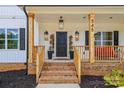 Inviting front porch with brick accents, stylish lighting, and a glimpse of the home's address at 545 Morrison Farm Rd, Troutman, NC 28166