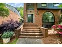 Brick staircase leading to the front door, complemented by well-kept landscaping and colorful flowers at 5807 Sharon Rd # A, Charlotte, NC 28210