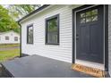 Close up of the front entrance showing the welcome mat, black door with glass panes, and fresh paint at 601 Whisnant St, Shelby, NC 28150