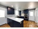 Renovated kitchen boasting sleek, custom blue cabinetry and stainless steel appliances at 8210 Lantana Dr, Denver, NC 28037