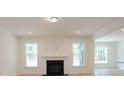 Cozy living room featuring a fireplace, hardwood floors, and plenty of natural light at Tbd Boomer Ct # 6, Statesville, NC 28677