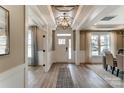 Inviting entryway with stylish light fixture, hardwood floors, and a modern white front door and decorative ceiling at Tbd Boomer Ct # 7, Statesville, NC 28677