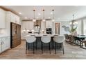 Bright, open kitchen featuring a large center island with pendant lighting and stainless steel appliances at Tbd Boomer Ct # 7, Statesville, NC 28677