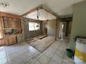 Living room featuring tile floors, a wooden cabinet, and exposed construction at 10625 Cool Springs Rd, Woodleaf, NC 27054