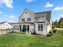 Expansive backyard featuring a covered patio area perfect for outdoor relaxation and entertainment at 11015 Benjamin Smith Ave, Huntersville, NC 28078
