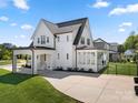 Long driveway leading to a beautiful home with a covered carport and well-maintained landscaping at 11015 Benjamin Smith Ave, Huntersville, NC 28078