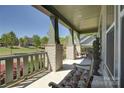 Relaxing covered front porch featuring comfortable seating and serene views of the landscaped yard at 1306 Kings Bottom Dr, Fort Mill, SC 29715