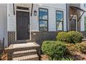 Inviting townhome entrance with brick steps, landscaping, and stylish exterior at 133 Capital Ave # B, Mooresville, NC 28117