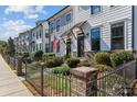 Attractive townhomes feature tidy landscaping, wrought iron fences, and inviting entryways at 133 Capital Ave # B, Mooresville, NC 28117