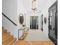 Bright and airy foyer featuring hardwood floors, modern light fixtures, and stylish accents at 1446 Townes Rd, Charlotte, NC 28209