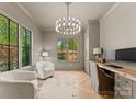 Comfortable office with natural light, hardwood floors, a chandelier and custom built-ins at 1446 Townes Rd, Charlotte, NC 28209