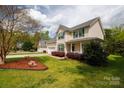 Two-story home featuring a driveway, attached garage and a well-maintained front lawn at 1540 Coatsworth Ln, Rock Hill, SC 29732