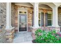 Inviting front porch with stone accents, dark door, and decorative plants at 17315 Langston Dr, Charlotte, NC 28278