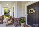 Inviting front porch with cozy seating and stylish decor, creating a warm and welcoming entrance at 17413 Caddy Ct, Charlotte, NC 28278