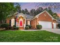 Inviting brick home with a red door, manicured lawn, and an attached two-car garage at 212 Kilborne Rd, Mooresville, NC 28117