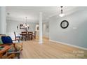 Open-concept living and dining area with hardwood floors and neutral paint at 212 Kilborne Rd, Mooresville, NC 28117