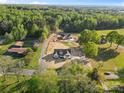 Expansive aerial view of a home site showcasing the neighborhood and verdant tree coverage at 215 Scout Rd, Locust, NC 28097