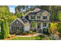 Beautiful exterior with a stone accent wall, manicured landscaping, and inviting front porch at 404 Brookridge Dr, Mount Holly, NC 28120